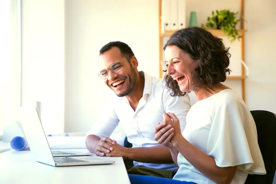 In-Home Computer Repair Technician Teaching Senior Woman To Use Her Laptop